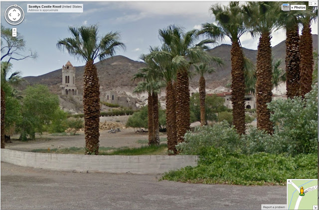 oasis in the arid desert with palm trees surrounding a castle