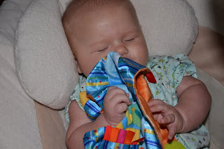 cute baby and Bright Starts Cuddle & Soothe Blanket.