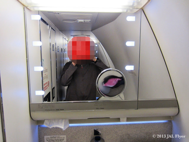 JAL First Class lavatory comes with a large shaving mirror.