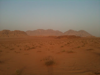 a desert with mountains in the background