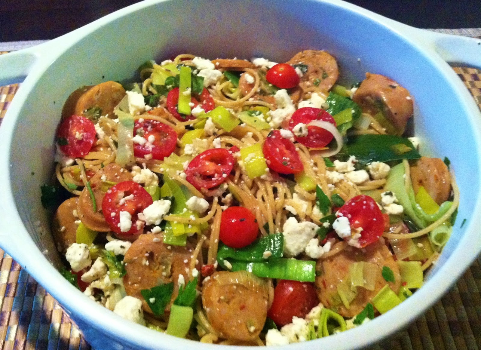 Whole wheat pasta tossed with chicken sausages, tomatoes, leeks, and