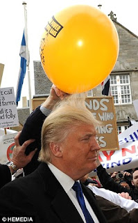 Donald Trump's hair encounters a latex balloon