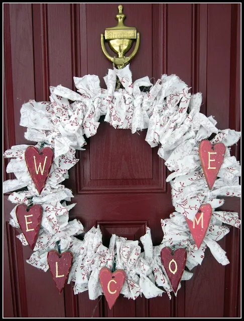 rag wreath with hearts that say welcome.