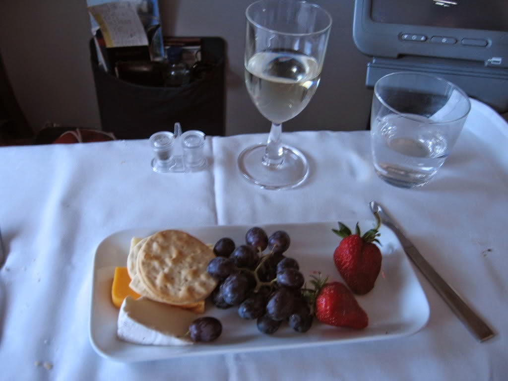 Cheese and Fruit Snack or Dessert Cheese and Fruit Snack or Dessert on white plate with wine glass of water on white table cloth