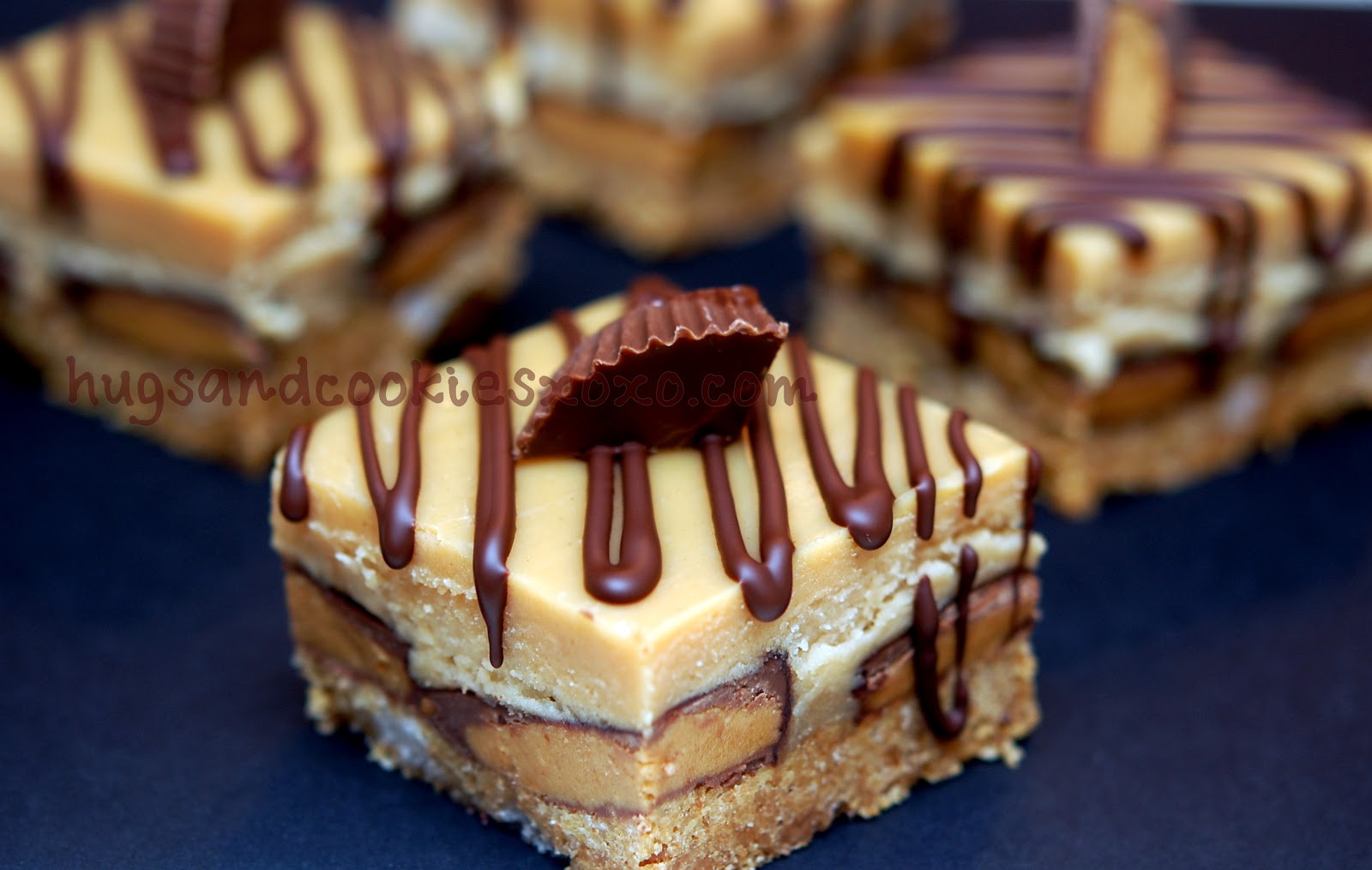 PEANUT BUTTER CHEESECAKE OVER PEANUT BUTTER CUPS SITTING ON A GRAHAM