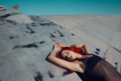 woman laying on airplane wing, fashion and beauty photographer nyc, jamie nelson