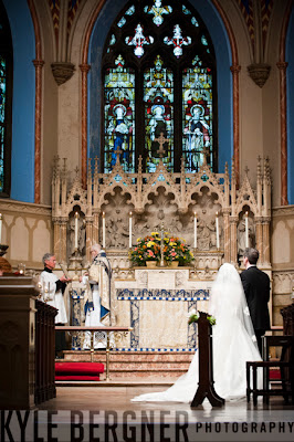 Bride and Groom standing at alter during catholic ceremony