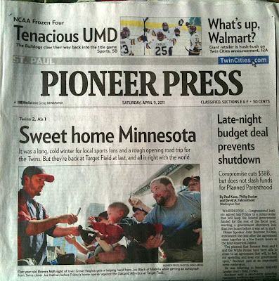 Front page of Pioneer Press with photo of young boy reaching toward baseball player