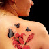Blue butterfly and flower tattoo on back body 