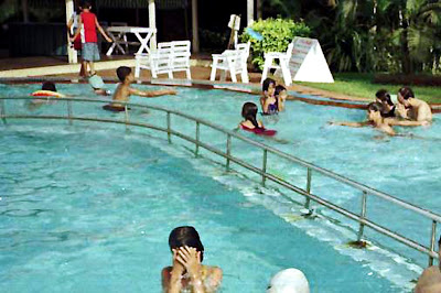 people swimming in hotel pool