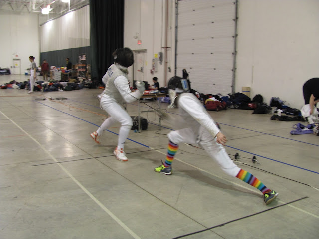 A fencing match in action