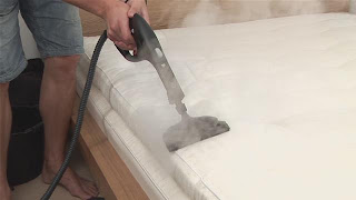 Steam Cleaning a mattress Man steam cleans a mattress