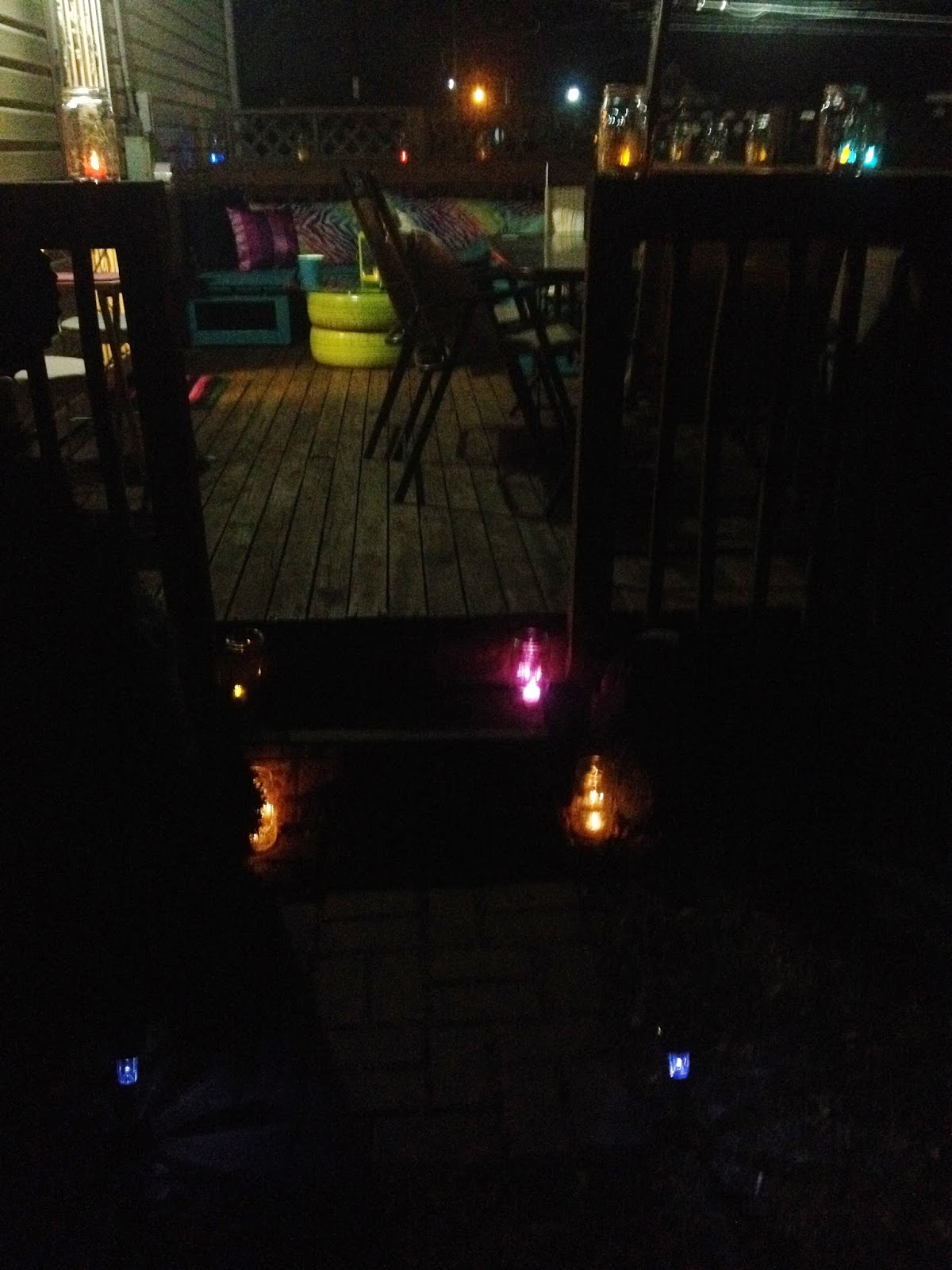 Colorful DIY outdoor deck seating benches makeover with tire table at night