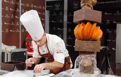 Swiss pastry chef David Pasquiet (C) prepares a chocolate creation during the 'World Chocolate Masters' contest at the Paris chocolate fair on October 28, 2013. Paris chocolate fair's 2013 edition will start from October 30 until November 3