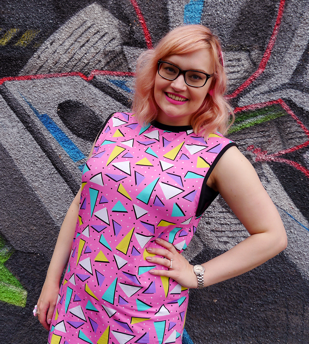 Dreamland Duplex print dress in pink Dreamland Duplex print dress, Saved by the Bell style, pom pom earrings, Alternate Normality candyfloss hairclip, River Island leather jacket, street style with graffiti