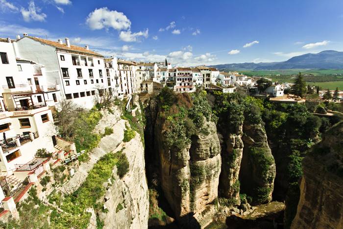 Ronda is a city in the Spanish province of Málaga. It is located about 100 kilometres (62 mi) west of the city of Málaga with a population of approximately 35,000 inhabitants. Ronda was first settled by the early Celts, who, in the 6th century BC, called it Arunda. Later Phoenician settlers established themselves nearby to found Acinipo, known locally as Ronda la Vieja, Arunda or Old Ronda. The current Ronda is however of Roman origins, having been founded as a fortified post in the Second Punic War, by Scipio Africanus