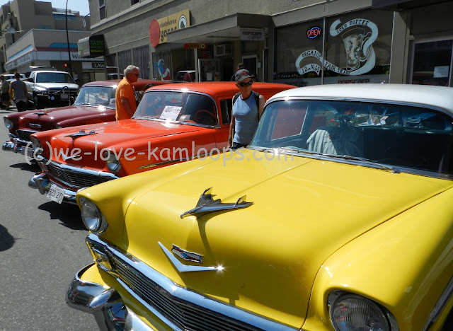 yellow, orange and red chevy's in a row on the street