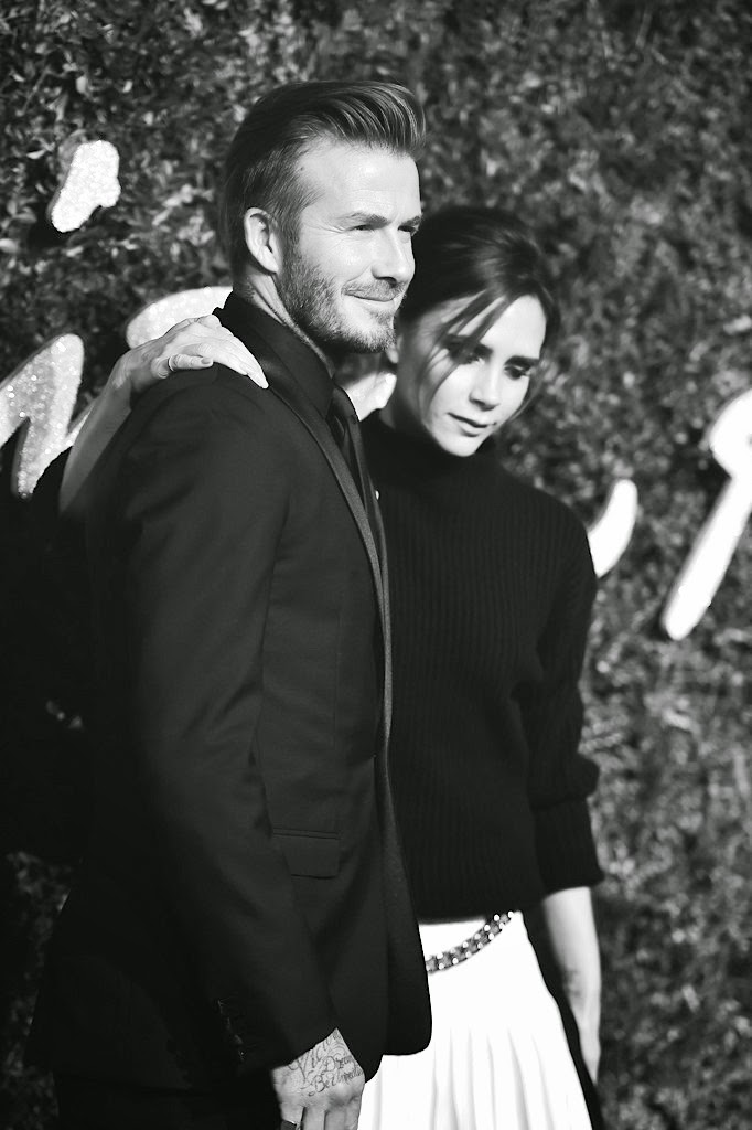 Victoria Beckham with David Beckham in Dior Homme tuxedo at 2014 British Fashion Awards