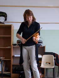 Our teacher playing a treble violin in class.