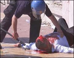 cop+beating+man+bloody.jpg