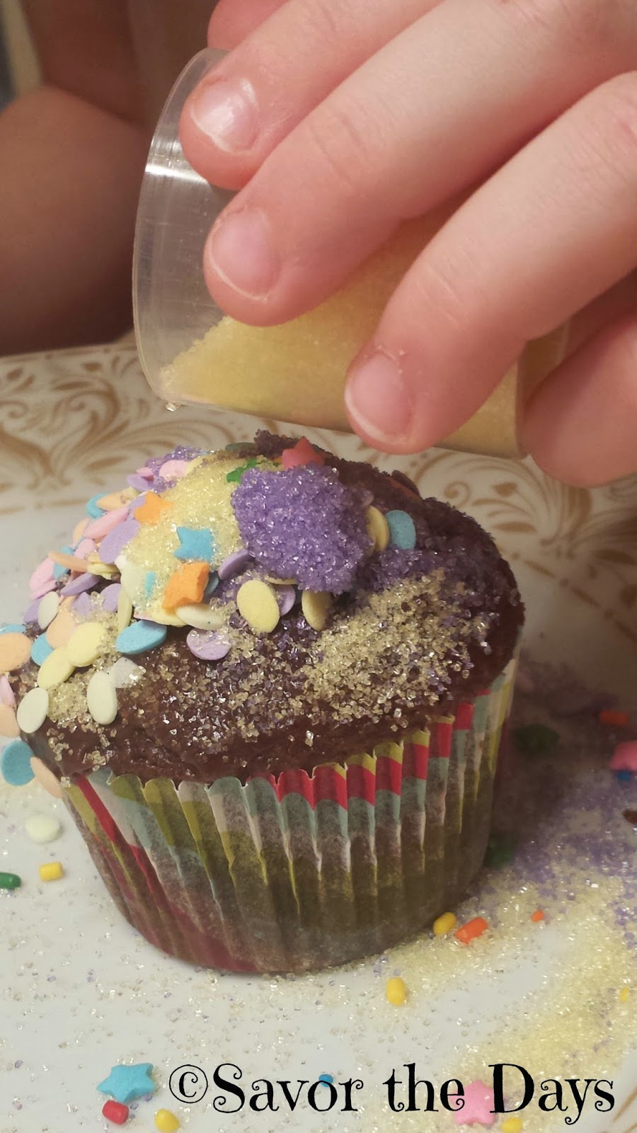 sprinkles and colored sugar on cupcake