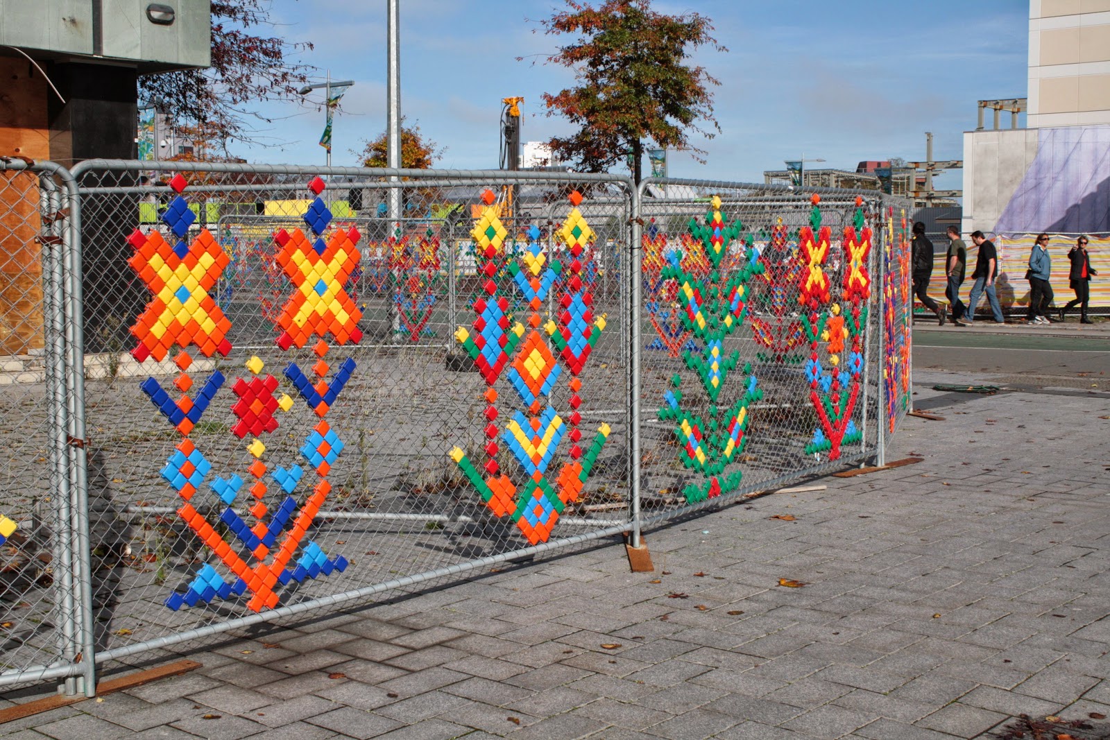 Plastic thingies stuck into hurricane fencing in the shape of flowers.