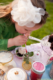 a little girl and a tea cup.