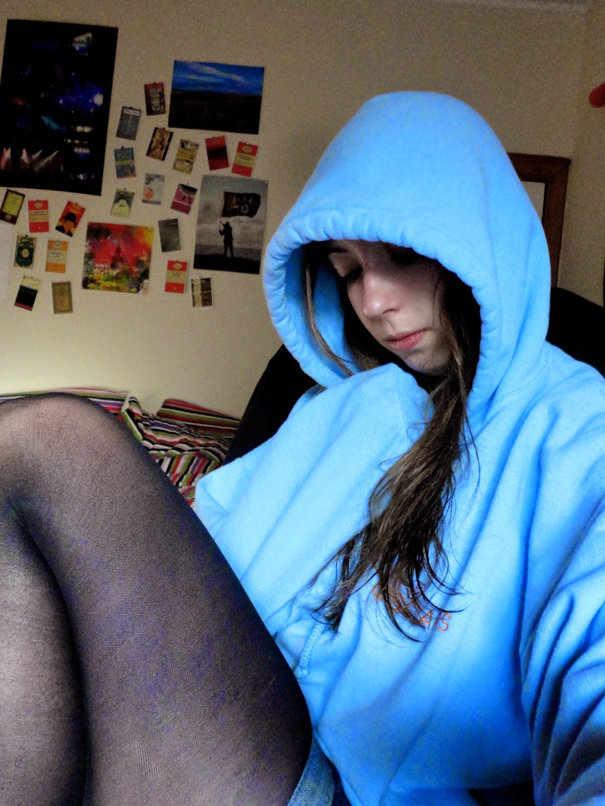girl wearing a large light blue hoodie
