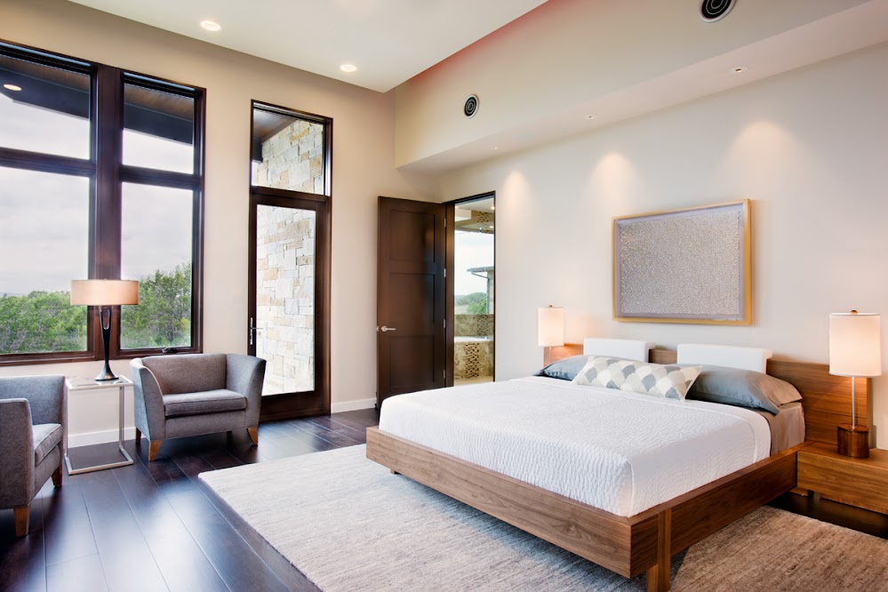 Photo of modern bedroom interiors with large bed and large windows