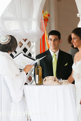 The Bride and Groom listening to the Rabbi during the wedding ceremony