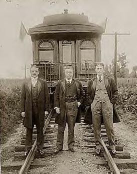 Roosevelt with others behind train, 1905