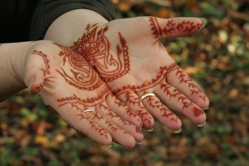 Henna designs henna hands and arms to decorate the baby is