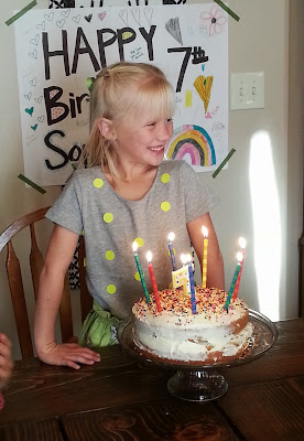 Birthday Girl a smiling little girl getting ready to blow out birthday candles on her cake