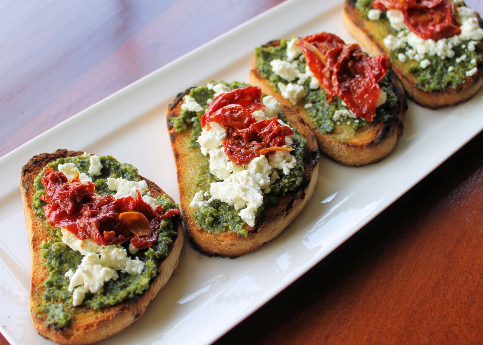 Savoir Faire Goat Cheese, Basil Pesto and Roasted Tomatoes Crostinis