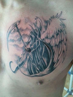 chest tattoo: Angel of Death / Grim Reaper depicted with archangel-like feathered wings