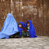An Afghan woman with her children on a cold day in Kabul
