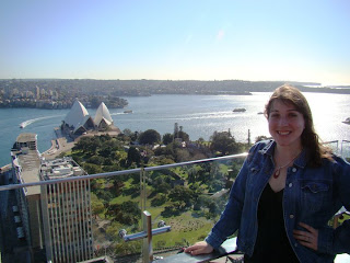 a woman standing on a balcony overlooking a city