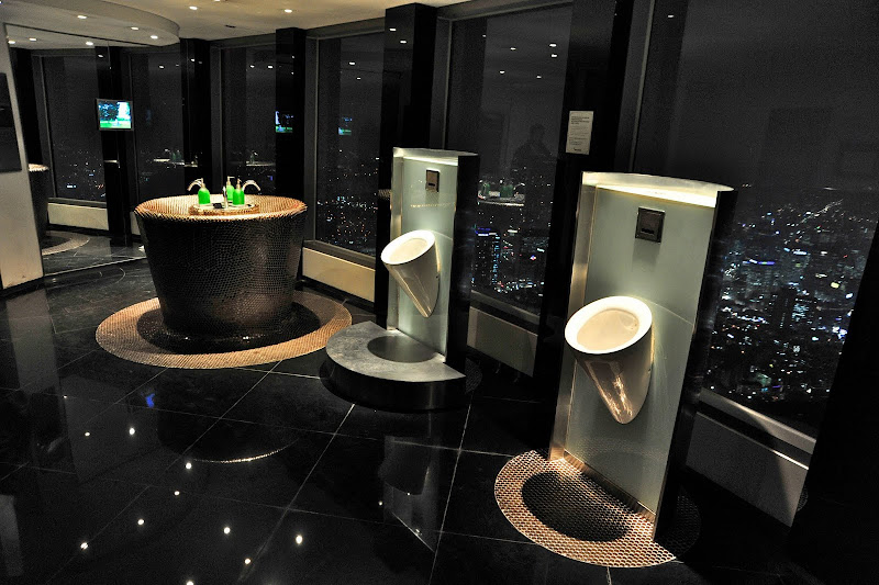 Beatifully designed urinals in the men's restroom overlook the city of title=