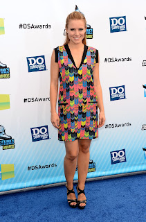 Kristen Bell posing in a short dress for cameras