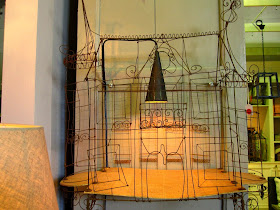 Vintage wire house, used as the basis for a lamp.