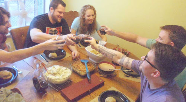 Giving a toast to Thanksgiving A group of friends toasting with wine over a Thanksgiving feast