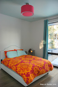 Aqua ceiling, pink drum shade, and pink and orange bedding- such a cute little girl's room.