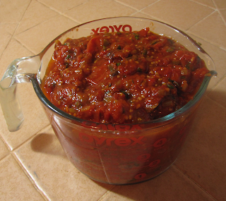 Large Cup Measure Filled with Tomato Sauce