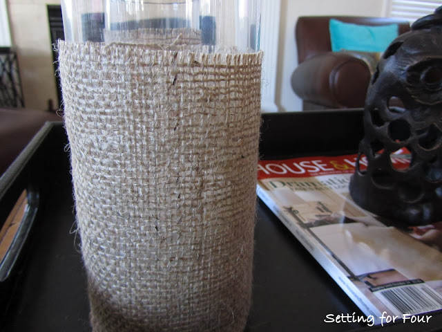 See this Quick and Easy way to dress up your hurricane candle holders with burlap! DIY Burlap Hurricane Sleeve with easy tutorial and supply list included.