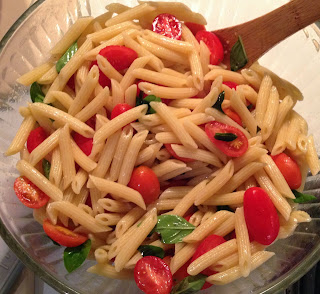 Pasta with coconut oil, basil, tomatoes and Parmesan cheese