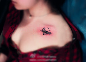 flying bird with letters tattoo