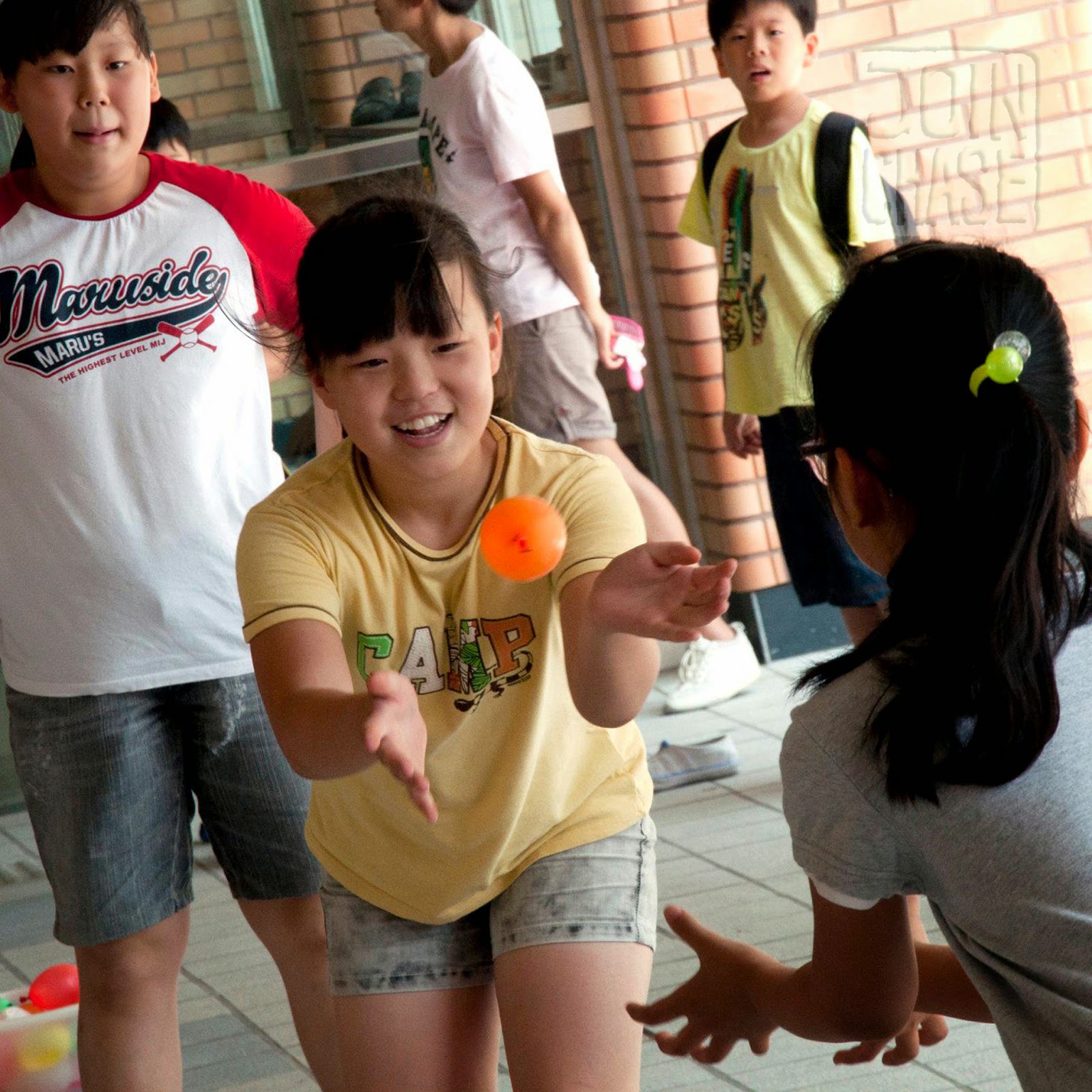 Water Balloon Toss Korean students tossing a water balloon in South Korea.