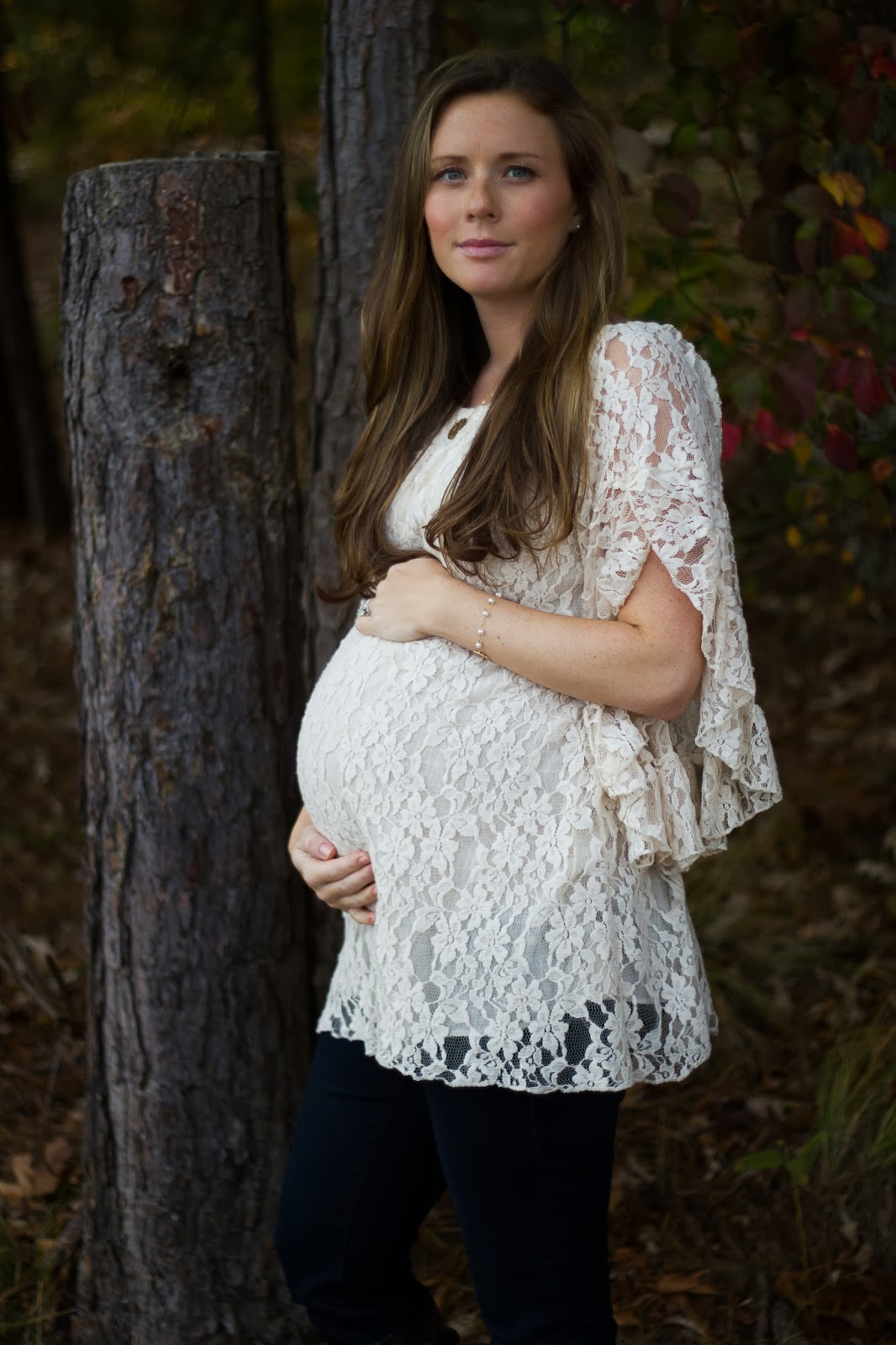 fall maternity shoot mom wearing lace dress and knee high boots at park