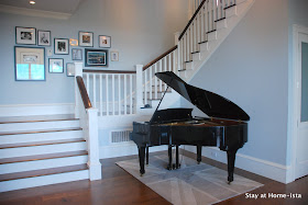 baby grand piano in the entry