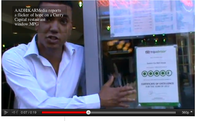 A flicker of business hope on a Brick Lane Curry Restaurant window. AADHIKAR Eid Mubarak report